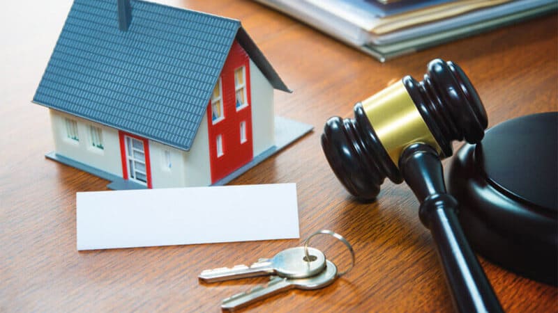 insolvency-sales-property Representation of insolvency property sales with a toy house and auction hammer