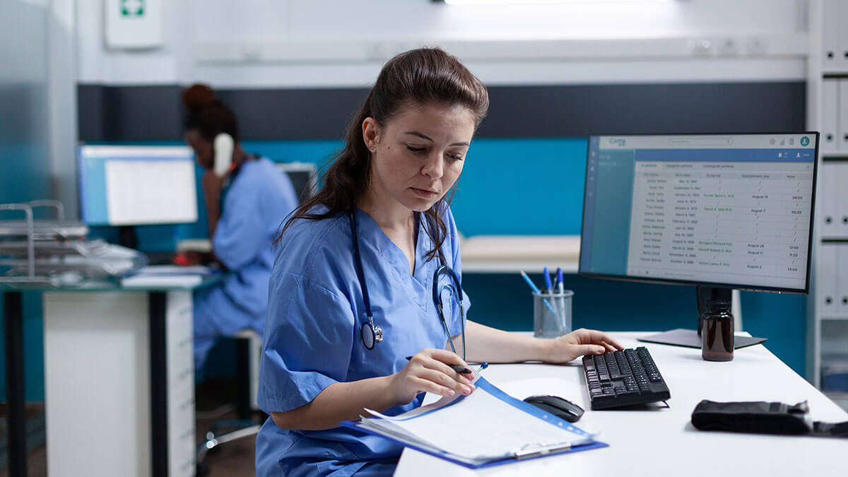 open-disclosure-blog-jan26 Healthcare worker dealing with open disclosure paperwork